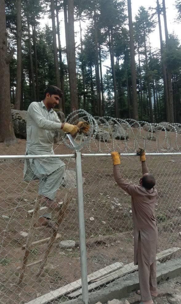 Kalam / Swat hill-area chain link with razor wire supporting photo